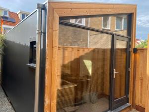 a large sliding glass door on a house at Tiny House The Wave in Ons Belang