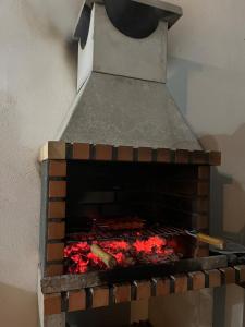 a brick oven with a fire inside of it at Casa Antonia in La Puebla de Montalbán