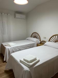 a room with two beds with towels on them at Casa Antonia in La Puebla de Montalbán +18 photos
