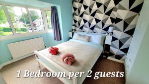 a bedroom with a bed with two towels on it at Yucca cottage in Kendal