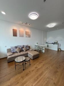 a living room with a couch and a table at The Calm Corner in Kota Samarahan