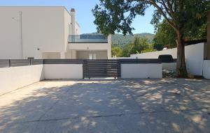 a white building with a bench and a tree at Holiday home Iva by Villas Guide in Vrulje