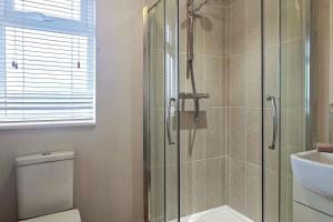 a bathroom with a shower and a toilet and a sink at 2 Bed in Evesham oc-f33689 in Offenham