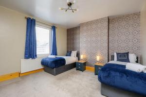a bedroom with two beds and a window at Brough Street 4 Bed, 5 Guests in Goole +27 photos