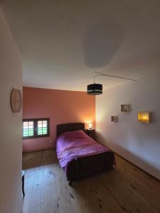 a bedroom with a bed and two windows at Maison Copé in Châtillon-sur-Broué