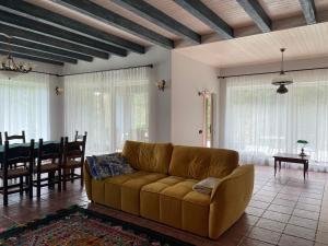 a living room with a couch and a dining room at Relaxation in Guta Гута покращене шале in Guta