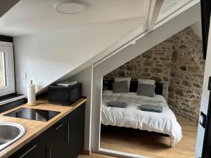a bedroom with a bed in the middle of a room at Petit cocon avec vue sur mer in Dinard