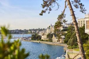 a view of a river with buildings and a city at Petit cocon avec vue sur mer in Dinard