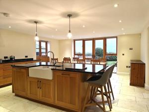 a large kitchen with a large island with a sink at 5 Bed in Langport oc-h33495 in Pitney +17 photos