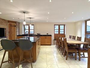 a kitchen with a table and chairs and a dining room at 5 Bed in Langport oc-h33495 in Pitney