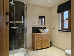 a bathroom with a glass shower and a sink at 5 Bed in Langport oc-h33495 in Pitney