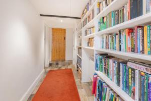 a library with white shelves filled with books at 2 Bed in Pooley Bridge oc-r33740 in Pooley Bridge