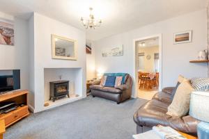 a living room with a couch and a fireplace at 2 Bed in Haverigg oc-s33747 in Haverigg