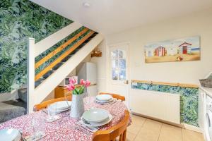 a dining room with a table and a staircase at 2 Bed in Haverigg oc-s33747 in Haverigg +10 photos