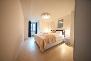 a bedroom with a white bed and a window at stuub schluchsee in Schluchsee