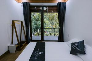 a bedroom with a bed and a window with a view at The Valley Lodge Trang An in Ninh Binh +46 photos