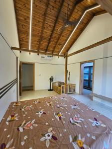 a large room with a bed with flowers on it at StayGuru Luxury Villa in Bhuj