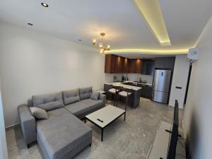 a living room with a couch and a kitchen at 'Ultra Luxury Holiday Apt in the Heart of the City in Alanya