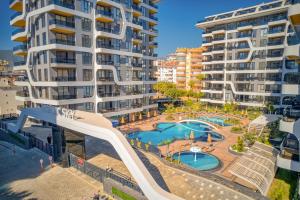 an image of an apartment complex with a slide at 'Ultra Luxury Holiday Apt in the Heart of the City in Alanya