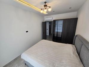 a bedroom with a bed and a couch at 'Ultra Luxury Holiday Apt in the Heart of the City in Alanya +27 photos