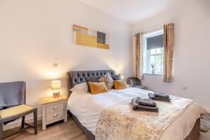 a bedroom with a bed and a chair and a window at 2 Bed in Newchapel oc-c33691 in Newchapel