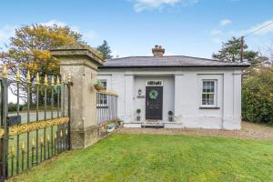 a white house with a gate and a yard at 2 Bed in Newchapel oc-c33691 in Newchapel
