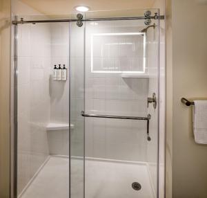 a shower with a glass door in a bathroom at Crowne Plaza Cleveland at Playhouse Square by IHG in Cleveland