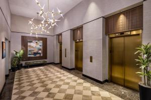 a lobby with a checkered floor and a chandelier at Crowne Plaza Cleveland at Playhouse Square by IHG in Cleveland +138 photos