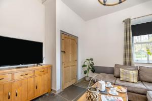 a living room with a couch and a flat screen tv at 2 Bed in Newchapel oc-c33691 in Newchapel