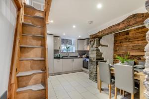 a kitchen with a brick wall and a wooden stairway at 2 Bed in Newchapel oc-c33691 in Newchapel +15 photos