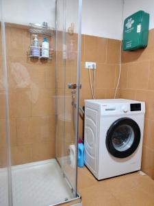 a washing machine in a shower in a bathroom at Casa Celia in Miranda del Rey