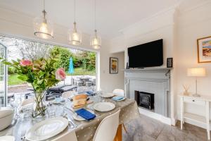 a dining room with a table and a fireplace at 4 Bed in Woolacombe oc-h33441 in Mortehoe