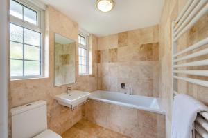 a bathroom with a tub and a sink and a toilet at 4 Bed in Woolacombe oc-h33441 in Mortehoe +36 photos