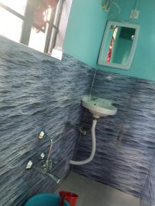 a bathroom with a sink and a mirror at deiphi and risa homestay in Pynursla