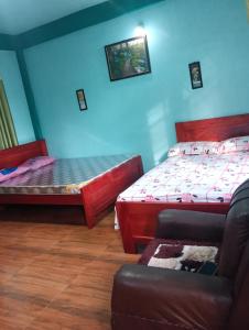a room with two beds and a couch at deiphi and risa homestay in Pynursla
