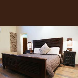 a bedroom with a large bed and two lamps at Lake Side Stays in Bhīm Tāl