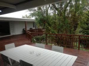 a white table and chairs on a deck at Addo Good Hope Guest House in Sunland