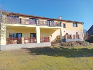a large house with a balcony on top of it at Penzion Burda in Žehrov