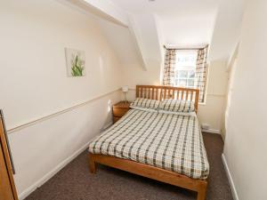a small bedroom with a bed and a window at Swallows Cottage in Walton East +25 photos