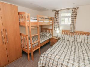 a bedroom with two bunk beds and a bed at Granary Cottage in Walton East +34 photos