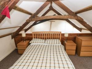 a bedroom with a bed and two night stands at Rafters Cottage in Walton East +38 photos