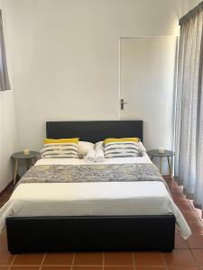a bedroom with a large bed with two tables at 326onMackenzieSt in Pretoria