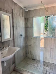 a bathroom with a sink and a shower at 326onMackenzieSt in Pretoria