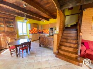 a kitchen with a table and a dining room at Bel Air in Peyrusse-le-Roc