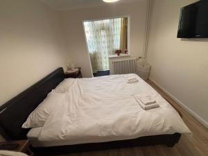 a bedroom with a bed with two towels on it at Elena Apartament in Suceava +2 photos