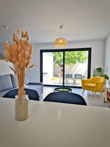 a living room with a white table and chairs at Maison du bonheur in Aytré +24 photos