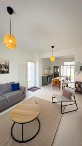 a living room with a couch and a table at Maison Du Marché in La Rochelle