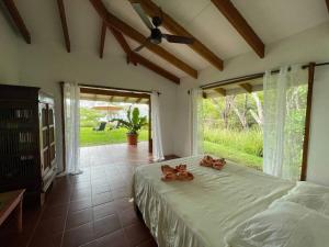 a bedroom with a bed with bows on it at Hidden Coast villa Frangipani Ocean & Jungle in Manzanillo +18 photos