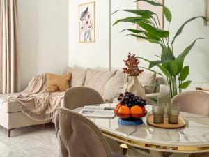 a living room with a table and a couch at Qoople Legend B - premium apartments steps from the sea in Alanya