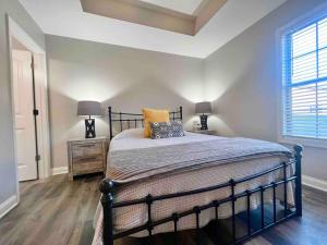 a bedroom with a bed and two lamps and a window at Modern 2bd 2ba - Near I75, No Steps, Free Wifi in Richmond